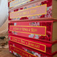 Stack of books titled 'A Court of Mist & Fury', 'A Court of Wings & Ruin', 'A Court of Frost & Starlight', and 'A Court of Silver' with floral designs on the covers.
