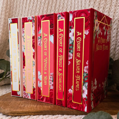 ACOTAR whole set with floral designs on white to red backgrounds.