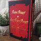 Red book titled 'Scary Stories' with black cover on a wooden surface.